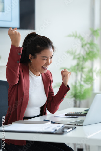 Happy office worker reading amazing job opportunity from laptop screen with positive emotion and excitement