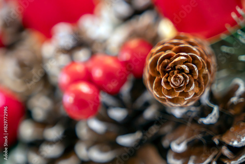 Pinecones and red berries create a festive atmosphere during the winter holiday season