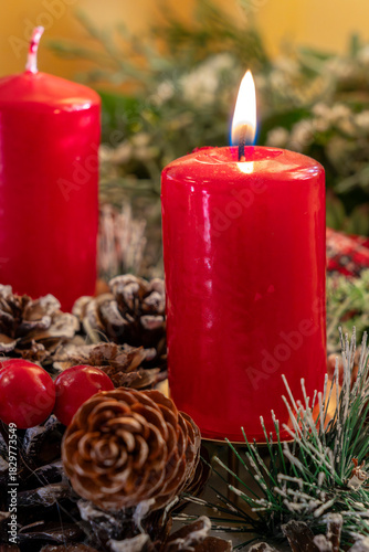 Bright red candles with pinecones and holiday decorations create a cozy atmosphere for a festive celebration during winter