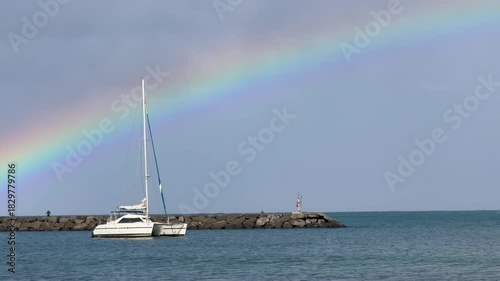 Rainbow over sailboat at Haleiwa Harbor on the Northshore of Oahu in the Hawaiian Islands. 