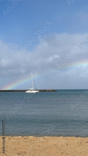 Rainbow over sailboat at Haleiwa Harbor on the Northshore of Oahu in the Hawaiian Islands. 