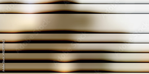 Abstract background of shiny metallic horizontal lines with soft focus and warm reflections.