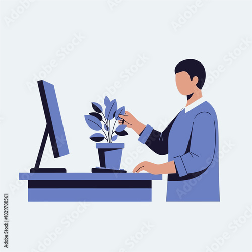 Man tending to plant at desk with computer.