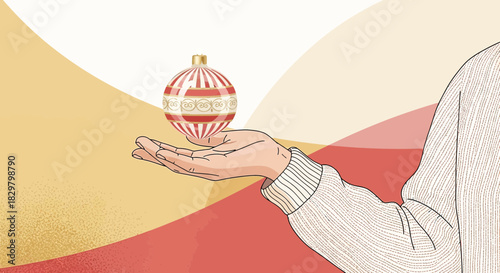 Elegant christmas ornament held in hand with festive abstract color background design