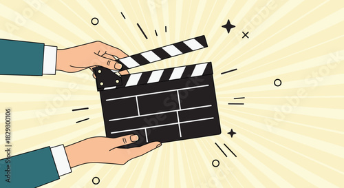 Two hands hold a movie clapperboard on a retro sunburst background to signal the start of filming a scene for a film.