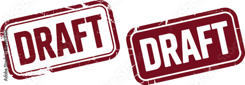 Two distressed rectangular rubber stamps clearly displaying the word DRAFT in a dark maroon color isolated on white