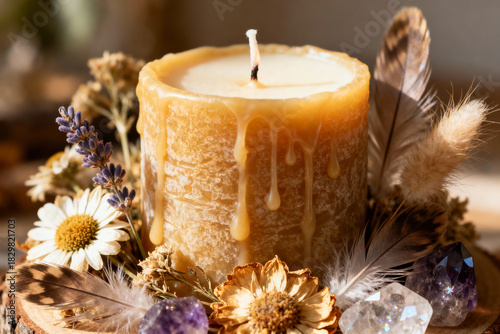 Rustic beeswax candle decorated with dried flowers and crystals  