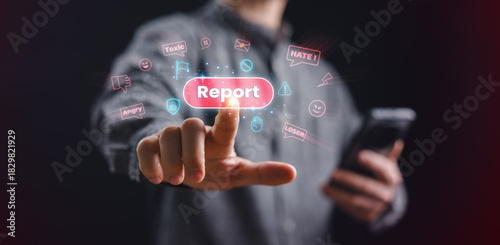 A person presses a glowing report button to stop toxic online messages, emphasizing cyberbullying prevention, digital safety, online protection, and awareness against harmful social media behavior.
