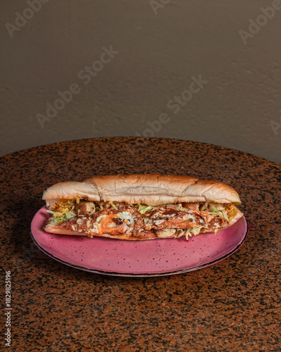 Long sandwiches with chicken breast, eggs, cabbage, cheese and dressing on plate