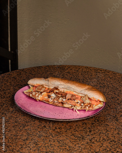 Long sandwiches with chicken breast, eggs, cabbage, cheese and dressing on plate