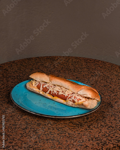 Hot dog with cheese on a plate
