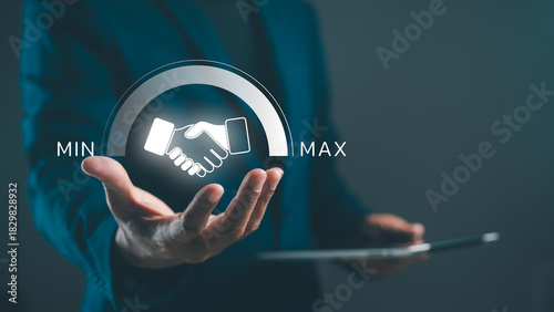 A professional hand gesture showcasing a handshake icon, symbolizing negotiation or agreement, with a focus on minimum and maximum values in a business context.