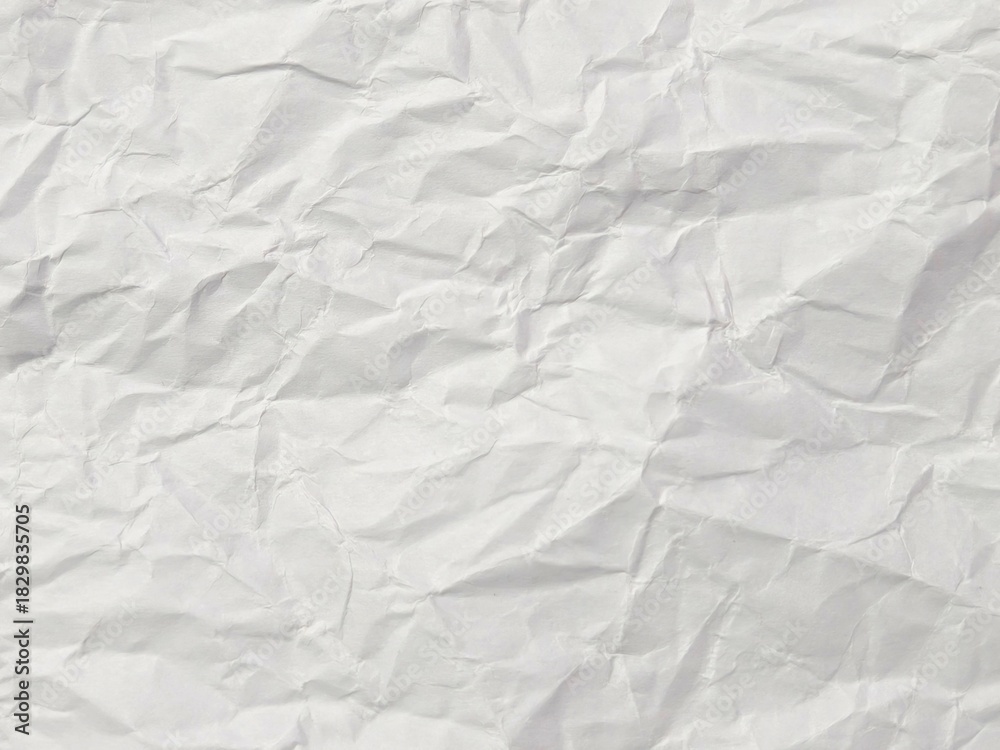 Obraz premium White Crumpled and Wrinkled Paper Texture. Abstract Background of Crushed and Folded Waste Paper for Web Design, Poster Mockups, or Photo Overlays.