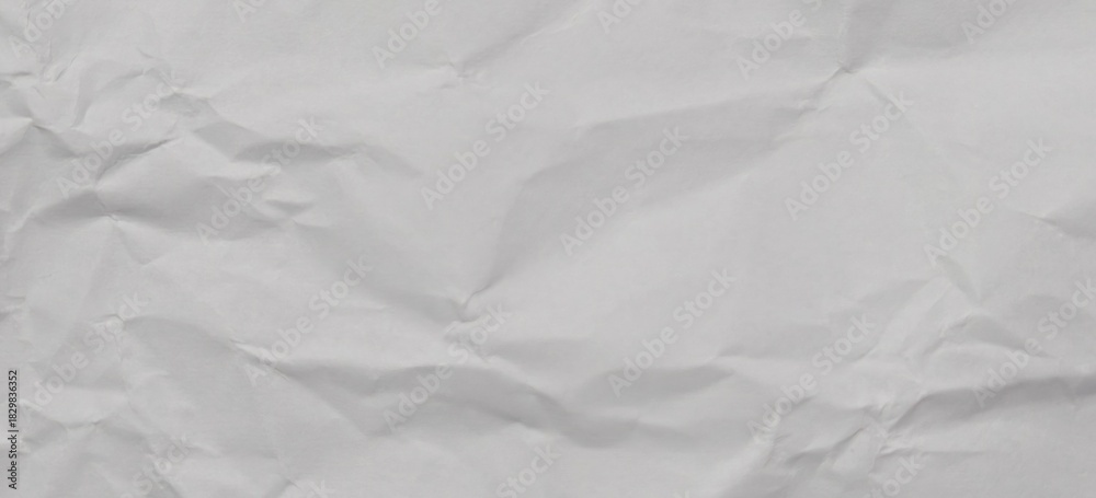 Obraz premium White Crumpled and Wrinkled Paper Texture. Abstract Background of Crushed and Folded Waste Paper for Web Design, Poster Mockups, or Photo Overlays.