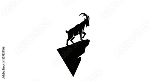Silhouette of a majestic mountain goat on a rocky peak.
