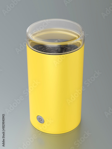 Yellow electric coffee grinder on grey metal table