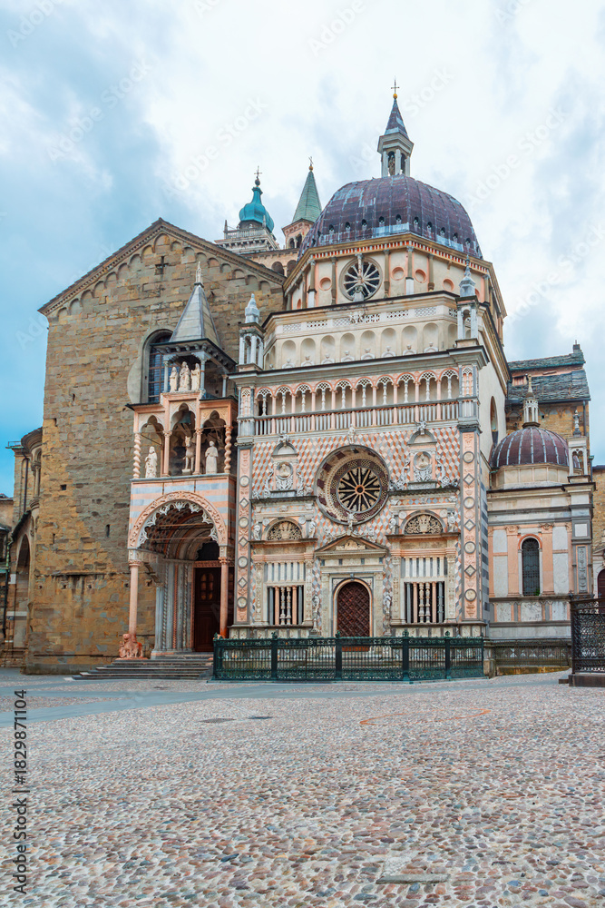 Obraz premium Facade of the ornate Colleoni Chapel in Bergamo old town, Citta Alta, Lombardy, Italy. Italian cobblestone city square with Renaissance and Lombard architecture. Vertical orientation