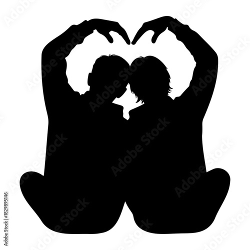 Silhouette of couple making heart shape with hands sitting together love
