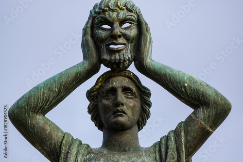 Close-up detail of the classical bronze figure from the Monument to Jacinto Benavente in Madrid’s Buen Retiro Park, Spain