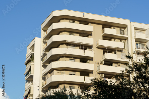 Cluster of neat modern apartments with external AC units stands near the Albanian waterfront. These features support tenant comfort, property sales, relocation interests, and real-estate agency offers