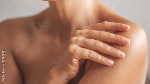 Woman applying body cream on arm, beauty skin care concept