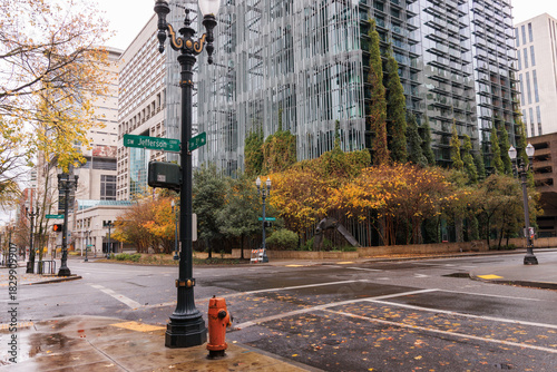 Intersection of Jefferson and 3rd Avenue in downtown Portland, Oregon with autumn colors and rainy conditions. 