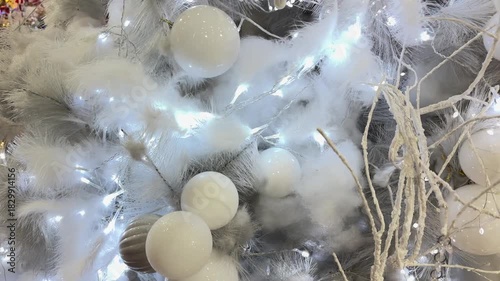 4k footage close up of lighted Christmas tree ornaments and decorations. Mistletoe, baubles, and bell with Interactive sparkling christmas twinkle lights or icicle lights.