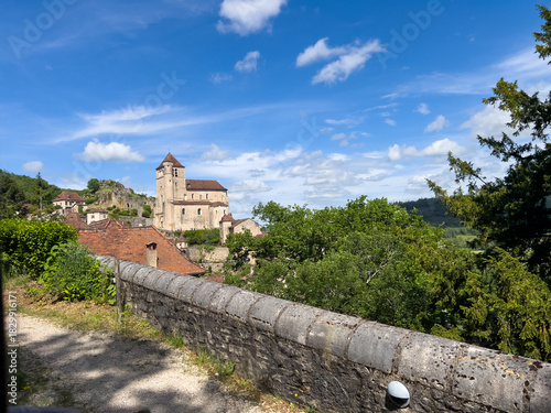 Saint Cirq Lapopie dominating the Lot valley in France under blue sky