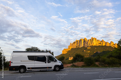 Camper van parked admiring Montserrat mountains at sunset