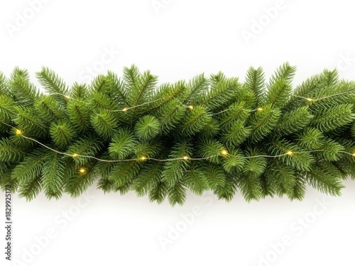 Close up of green artificial christmas garland with delicate warm white fairy lights strung across the pine branches, isolated on white background
