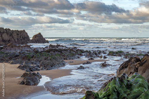 Cornish South West rock and sandy coast at dawn in winter