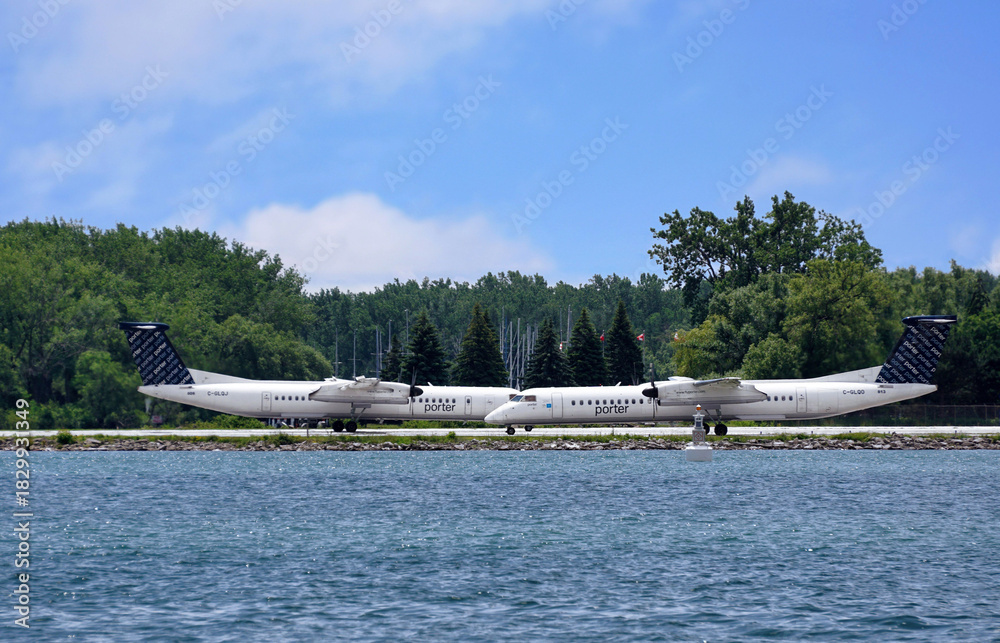 Fototapeta premium Turboprop airplanes on the runway at Toronto Billy Bishop downtown waterfront airport