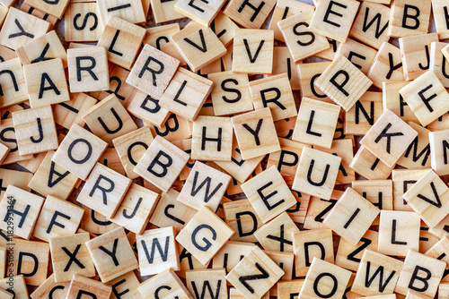 Alphabet letters on wooden block pieces, from above.Close up of Wooden letter cubes.Challenge and solution concept.Hobbies and leisure activities