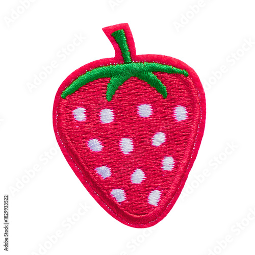 Close-up of a cute embroidered strawberry patch. This red fruit applique with a green leaf is isolated on a transparent background, ideal for sewing and craft projects