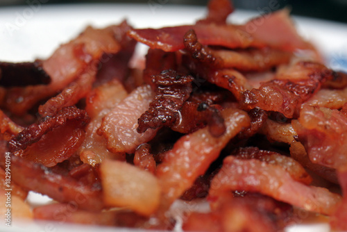 Macro close-up of a pile of crispy fried bacon pieces