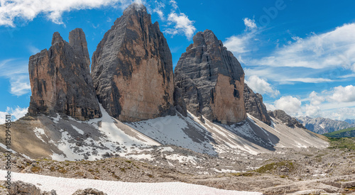 Tre Cime di Lavaredo peaks in the Dolomites mountains with snow patches, Cortina d'Ampezzo, Belluno, Italy. Italian Dolomiti Alps, Trentino, Alto Adige. Travel and touristic destination