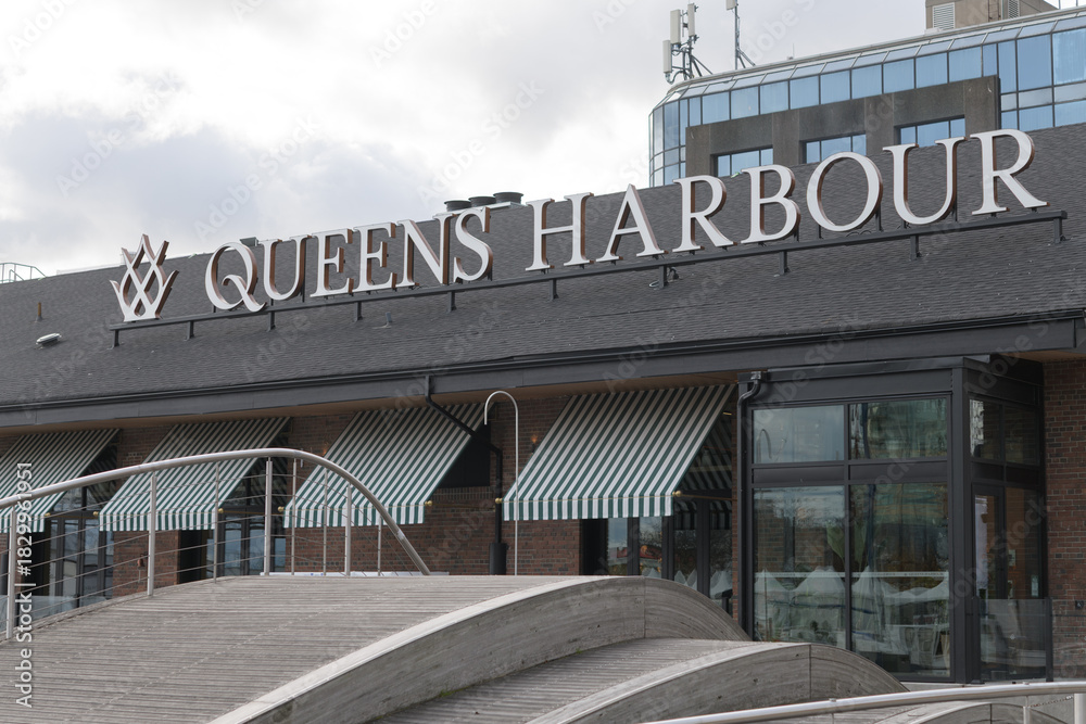 Fototapeta premium exterior building and sign of Queens Harbour, a Mediterranean restaurant, located at 245 Queens Quay W, Toronto