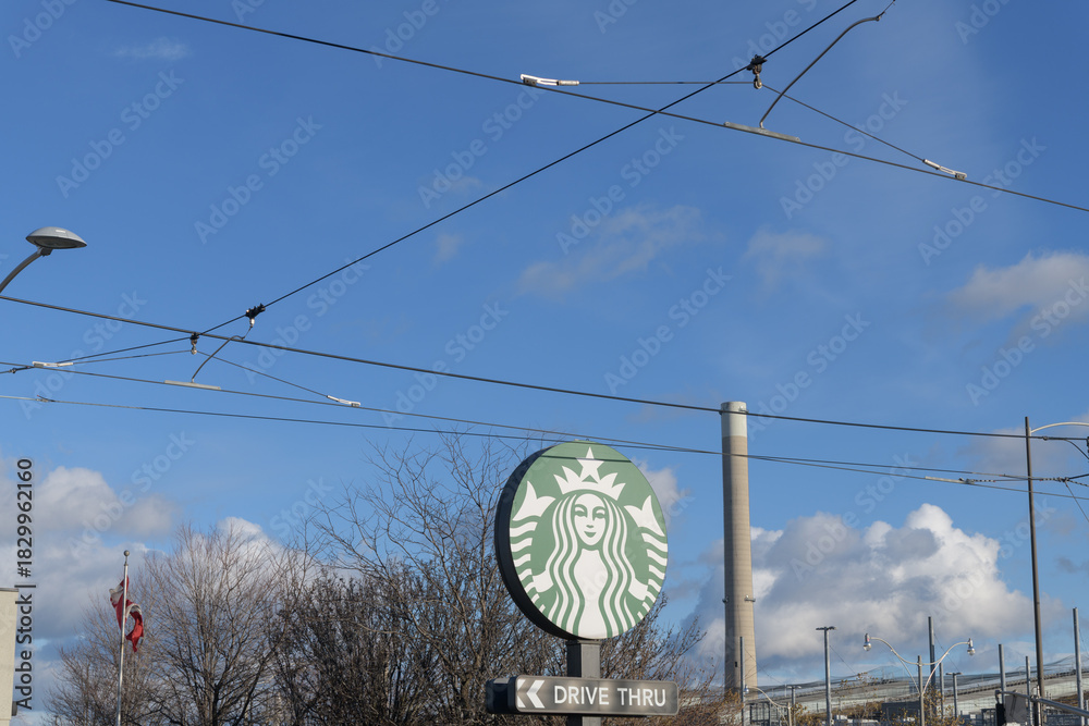 Fototapeta premium round Mermaid logo sign of Starbucks, a coffee shop chain, located here at 23 Leslie St, Toronto