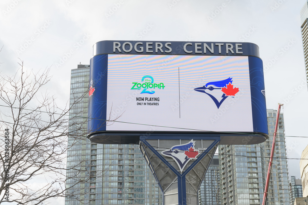 Fototapeta premium roadside digital billboard outside Rogers Centre feat movie promotion for Zootopia 2, with Blue Jays logo, Toronto