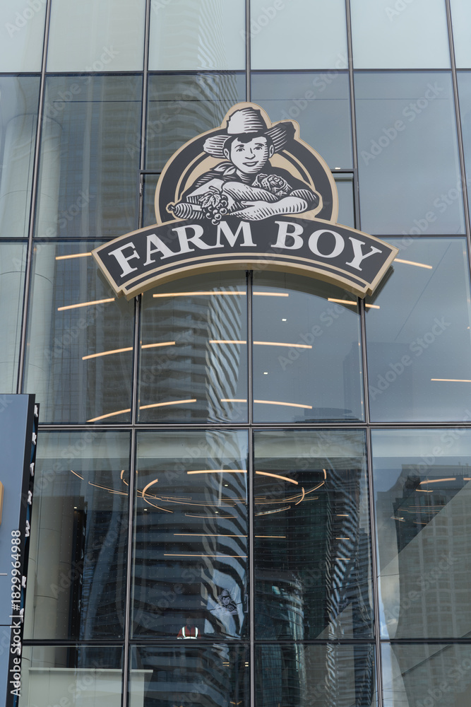 Obraz premium exterior building facade and sign of Farm Boy, a fresh food market, located here at 100 Queens Quay E, Sugar Wharf Condominiums, Toronto
