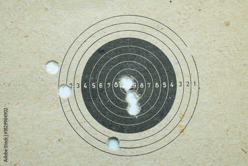 Paper shooting target with bullet holes
