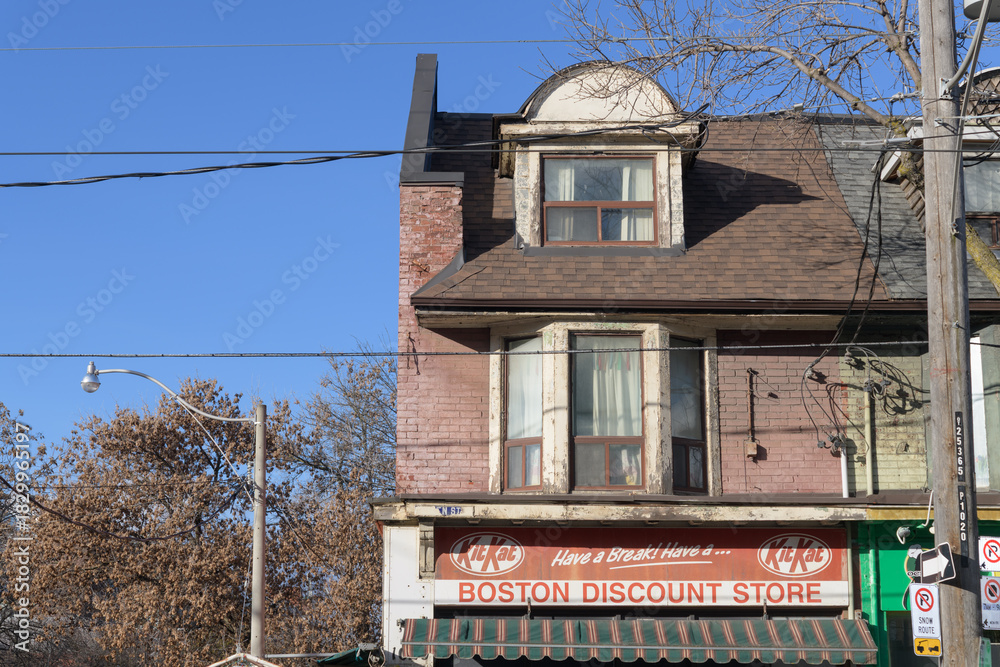 Obraz premium exterior building facade and sign of Boston Discount Store located at 1020 Queen St E, Toronto