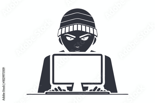 Silhouette figure with mask and beanie uses a laptop in a monochrome image