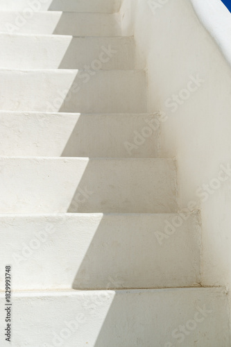 Abstract view of typical greek architecture detail of rustic outside steps to a rooftop in a white-washed sugar cube village