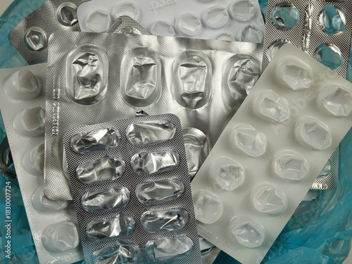 Heap of empty pill blister packs, used pill pack blisters top view. Treatment and medication concept
