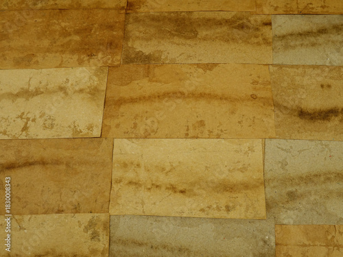 Paper collage of various type of pack paper in brown tones on cardboard. Paper background in a retro style