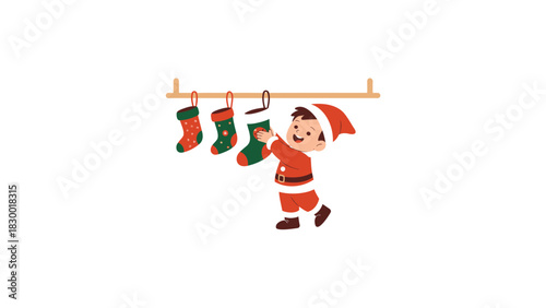 Joyful little boy dressed as santa claus happily hanging christmas stockings on a wooden rack for holiday gifts