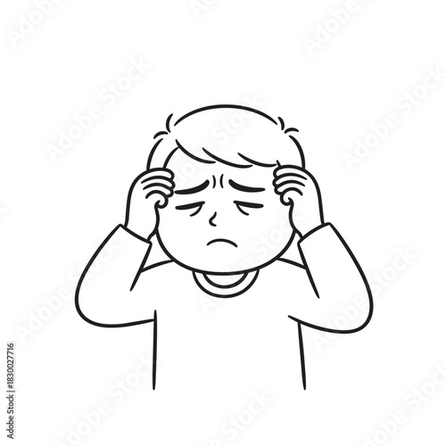 Boy holding head in discomfort with a pained expression  