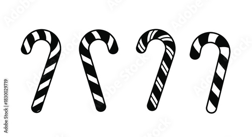 Four black and white striped candy canes in a simple arrangement