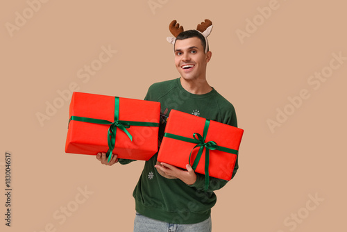 Happy young man in reindeer...